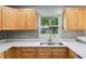 This kitchen features stainless sink, quartz counters, modern wood cabinets, and tile backsplash at 2704 Yule Tree Dr, Edgewater, FL 32141