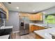 This modern kitchen features stainless steel appliances, stylish wood cabinets, and quartz countertops at 2704 Yule Tree Dr, Edgewater, FL 32141