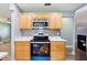 Well-lit kitchen featuring stainless steel appliances, modern wood cabinets, and quartz counters at 2704 Yule Tree Dr, Edgewater, FL 32141