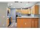 Modern kitchen features stainless steel appliances and quartz countertops and bar area for seating at 2704 Yule Tree Dr, Edgewater, FL 32141