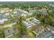 An aerial view shows the community and neighborhood with mature trees and multiple buildings in the complex at 2826 Ne 7Th St, Ocala, FL 34470