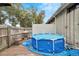 Backyard deck view showcasing Intex pool surrounded by privacy fence and lush foliage at 2826 Ne 7Th St, Ocala, FL 34470