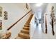 Hallway featuring carpeted stairs and tile flooring leading to the living area at 2826 Ne 7Th St, Ocala, FL 34470