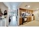 Kitchen flowing to the living room with appliances and wood cabinetry at 2826 Ne 7Th St, Ocala, FL 34470