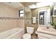 Bright bathroom featuring a bathtub, neutral tile, and granite vanity with classic fixtures at 2928 Lake Pineloch Blvd # Ge, Orlando, FL 32806