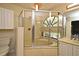 Bathroom features an enclosed tub with large arched window offering outdoor views, and a separate shower stall at 2928 Lake Pineloch Blvd # Ge, Orlando, FL 32806