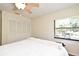Bedroom featuring a queen size bed, wood floors, window, and bi-fold closet door at 2928 Lake Pineloch Blvd # Ge, Orlando, FL 32806