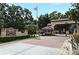 Welcoming entrance to the community with lush landscaping, guard house, and an American flag at 2928 Lake Pineloch Blvd # Ge, Orlando, FL 32806