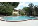 Large community pool surrounded by lounge chairs and lush landscaping, perfect for relaxation at 2928 Lake Pineloch Blvd # Ge, Orlando, FL 32806