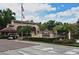 Welcoming entrance to Lake Pineloch Village with lush landscaping, flags, and a manned guard house at 2928 Lake Pineloch Blvd # Ge, Orlando, FL 32806