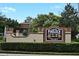 Lake Pineloch Village sign surrounded by well-maintained landscaping and mature trees at 2928 Lake Pineloch Blvd # Ge, Orlando, FL 32806