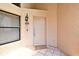 Inviting front door with tile flooring and a security light, creating a secure and welcoming entrance at 2928 Lake Pineloch Blvd # Ge, Orlando, FL 32806
