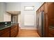 Open kitchen with hardwood floors, wooden cabinets, stainless steel appliances, and a convenient breakfast bar at 2928 Lake Pineloch Blvd # Ge, Orlando, FL 32806