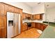This kitchen features stainless steel appliances and wooden cabinets, complemented by granite countertops at 2928 Lake Pineloch Blvd # Ge, Orlando, FL 32806