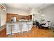 Open kitchen with breakfast bar, stainless appliances, and a dining area with a modern chandelier at 2928 Lake Pineloch Blvd # Ge, Orlando, FL 32806
