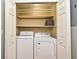 Bright laundry room with in-unit washer and dryer, plus shelves for storage inside a closet at 2928 Lake Pineloch Blvd # Ge, Orlando, FL 32806