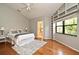 Bright main bedroom features hardwood floors, custom built-ins, and a view to the ensuite bathroom at 2928 Lake Pineloch Blvd # Ge, Orlando, FL 32806