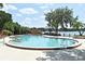 Sparkling community swimming pool with comfortable lounge chairs and views of the lake at 2928 Lake Pineloch Blvd # Ge, Orlando, FL 32806