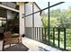 Relaxing screened in porch with tile floor, ceiling fan, and comfortable chairs overlooking the backyard at 2928 Lake Pineloch Blvd # Ge, Orlando, FL 32806