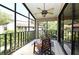 Relaxing screened in porch with tile floor, ceiling fan, and comfortable chairs overlooking the neighborhood at 2928 Lake Pineloch Blvd # Ge, Orlando, FL 32806