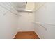 Walk-in closet with wood floor and white wire shelving on all three walls at 2928 Lake Pineloch Blvd # Ge, Orlando, FL 32806