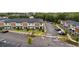 Aerial view showcasing a modern townhome community with well-maintained landscaping and ample parking spaces at 3301 Tranquil Trl, Kissimmee, FL 34747