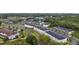 Wide aerial view of a neighborhood of townhomes surrounded by greenery and community amenities at 3301 Tranquil Trl, Kissimmee, FL 34747