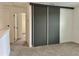Bedroom features new carpet, large closet doors, and two entry doors at 3301 Tranquil Trl, Kissimmee, FL 34747