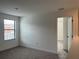 Bright bedroom with a large window, neutral carpet and ample closet space at 3301 Tranquil Trl, Kissimmee, FL 34747