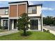 Contemporary home exterior with a manicured lawn and black trim at 3301 Tranquil Trl, Kissimmee, FL 34747