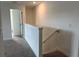 Upstairs hallway with access to bedrooms and a stairway with railing at 3301 Tranquil Trl, Kissimmee, FL 34747
