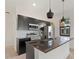 Modern kitchen featuring stainless steel appliances, granite countertops, and island seating at 3301 Tranquil Trl, Kissimmee, FL 34747