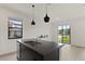 Modern kitchen with stainless steel appliances, granite countertops, and contemporary pendant lights at 3301 Tranquil Trl, Kissimmee, FL 34747