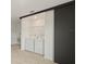 Convenient laundry room with washer, dryer, wire shelving, and sliding door at 3301 Tranquil Trl, Kissimmee, FL 34747