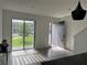 Bright living room with natural light, modern sliding glass door and neutral flooring at 3301 Tranquil Trl, Kissimmee, FL 34747
