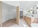 Bright bathroom featuring double vanity, modern mirrors, and walk-in closet for ample storage at 388 Hampton Hills Ct, Debary, FL 32713