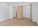Bright bedroom with hardwood floors featuring closet space and an adjacent doorway at 388 Hampton Hills Ct, Debary, FL 32713