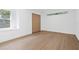 Well-lit bedroom featuring hardwood floors, a window, and a double door closet at 388 Hampton Hills Ct, Debary, FL 32713