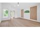 Minimalist bedroom with hardwood floors, white walls and natural light from surrounding windows at 388 Hampton Hills Ct, Debary, FL 32713