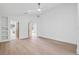 Spacious bedroom with white walls, wood floors, and modern ceiling fan at 388 Hampton Hills Ct, Debary, FL 32713