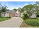 Beautiful home exterior features an attached garage, well-manicured lawn, and architectural pillars at 388 Hampton Hills Ct, Debary, FL 32713