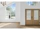 Bright foyer with large windows, double doors, and hardwood floors at 388 Hampton Hills Ct, Debary, FL 32713