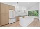 Bright open kitchen featuring stone countertops, stainless steel appliances, custom cabinets, and a garden view at 388 Hampton Hills Ct, Debary, FL 32713
