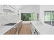 Bright open kitchen featuring stone countertops, stainless steel appliances, custom cabinets, and a range at 388 Hampton Hills Ct, Debary, FL 32713