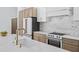 Close-up of a kitchen island with marble countertop, gold faucet, and modern appliances at 388 Hampton Hills Ct, Debary, FL 32713