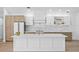 Bright open kitchen featuring stone countertops, stainless steel appliances, and custom cabinets at 388 Hampton Hills Ct, Debary, FL 32713