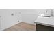 Laundry area features a white quartz countertop, wood-look floors and connections for a washer and dryer at 388 Hampton Hills Ct, Debary, FL 32713