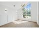 Empty, bright living room with hardwood floors and large windows at 388 Hampton Hills Ct, Debary, FL 32713