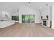 Spacious living room with hardwood floors, fireplace, vaulted ceilings, and access to a screened lanai at 388 Hampton Hills Ct, Debary, FL 32713