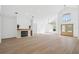 Bright open floor plan with a stone fireplace, hardwood floors, and plenty of natural light at 388 Hampton Hills Ct, Debary, FL 32713
